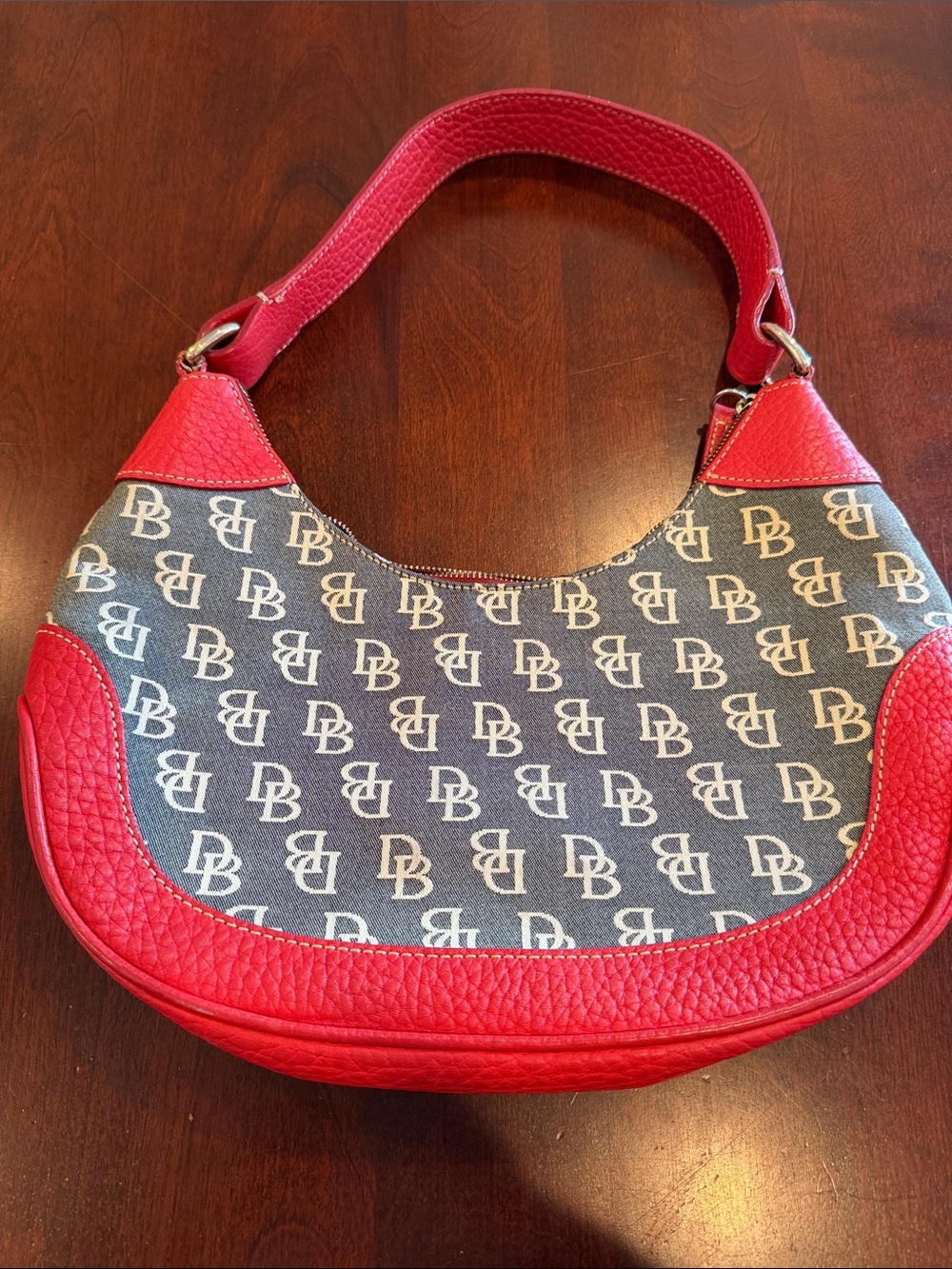 Dooney & Bourke Denim leather accent on bottom and top along with strap Handbag